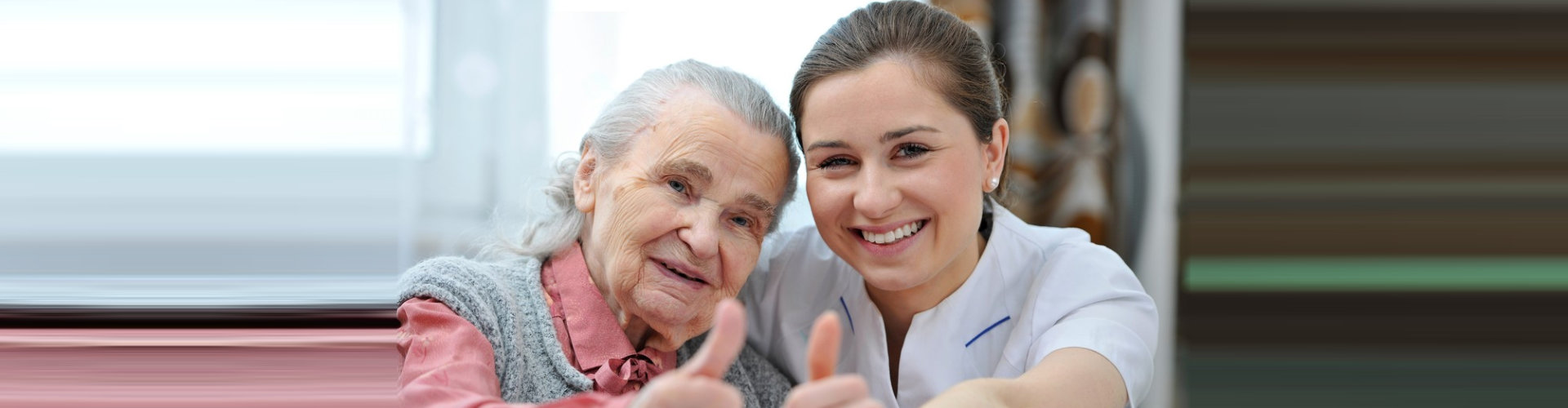 female caregiver and her old woman doing thumbs up